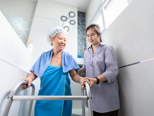 carer assisting senior woman