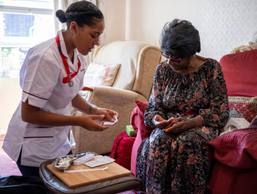 healthcare worker giving medications to the elderly woman