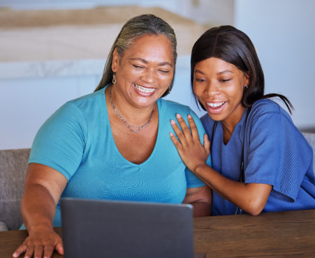 carer and elderly woman smiling