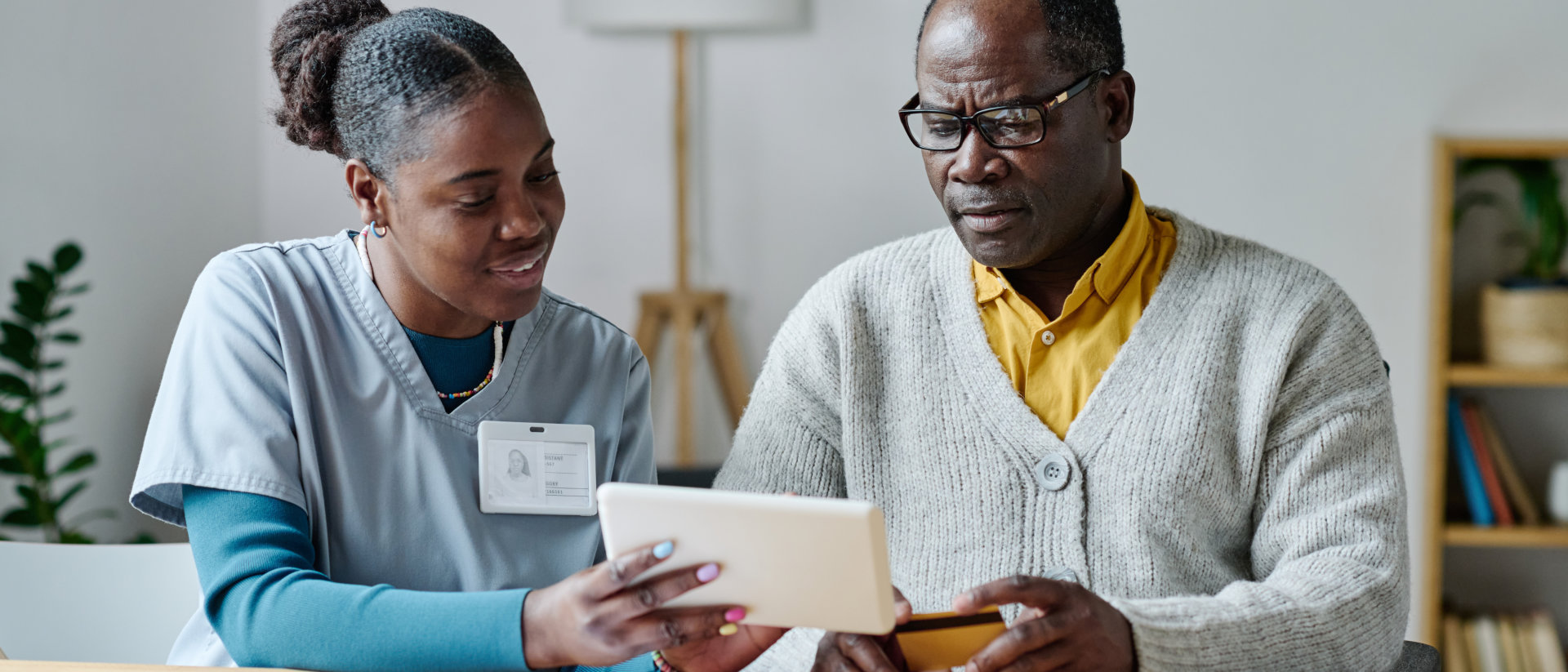 senior man with carer at home