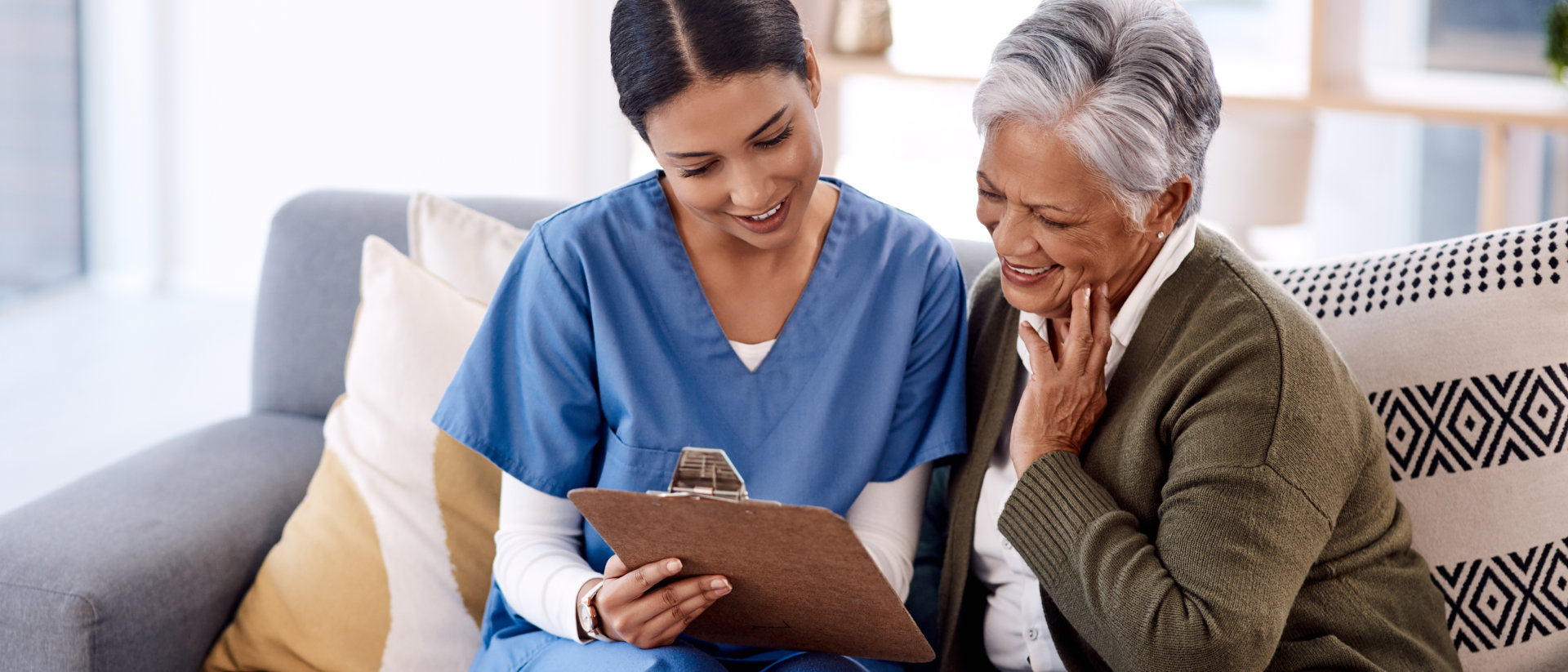 elderly woman and carer smiling