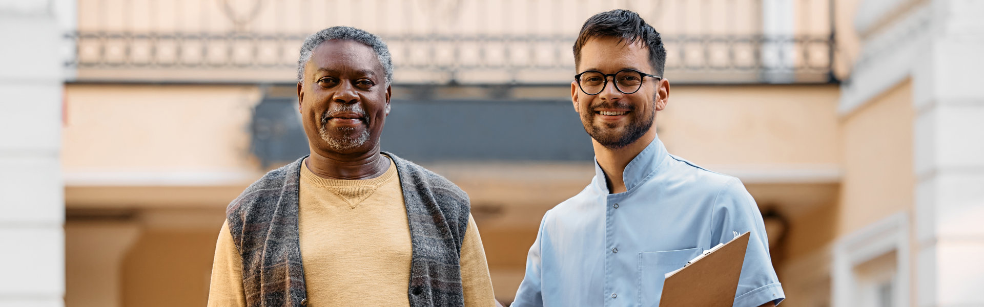 man holding a clipboard with elderly man