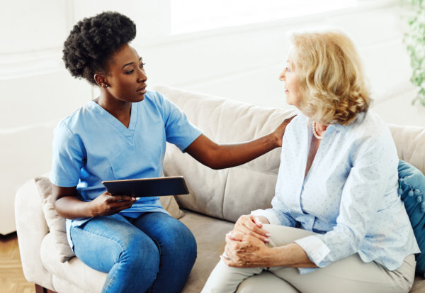 carer comforting an elderly woman