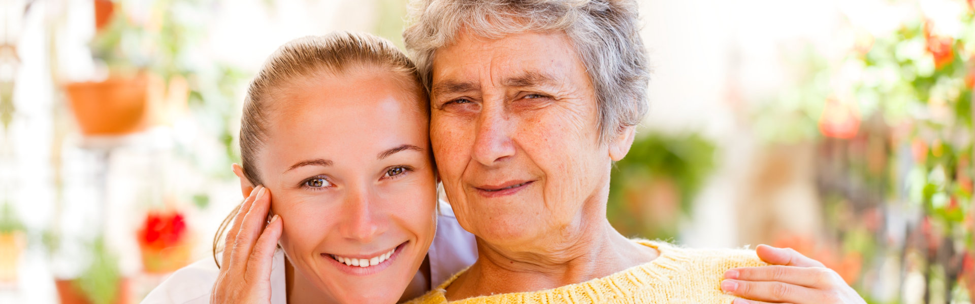 carer and senior woman smiling