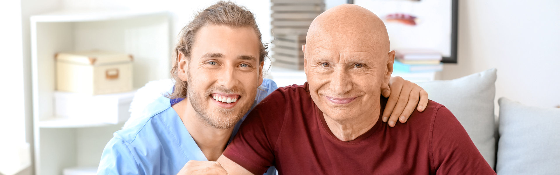 carer and elderly man smiling together