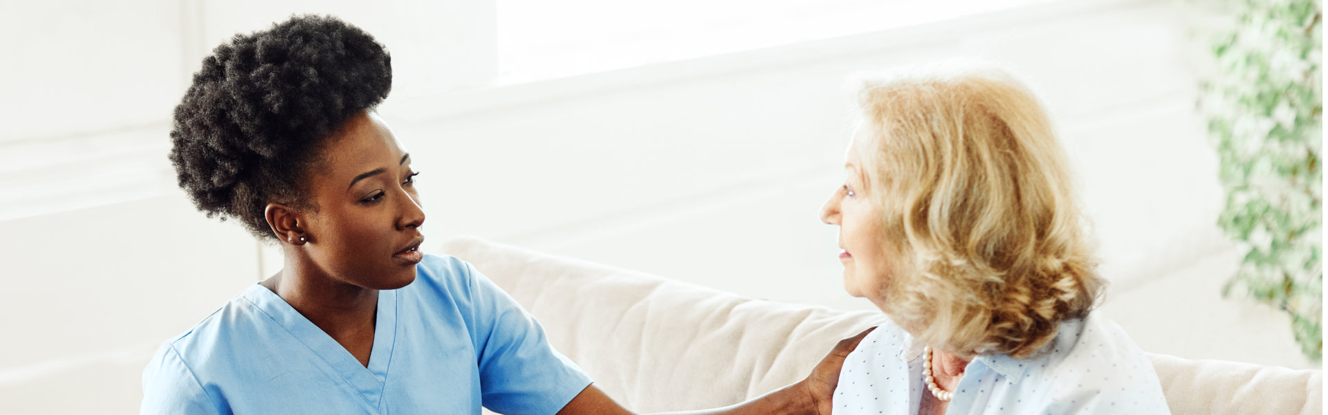 carer comforting an elderly woman